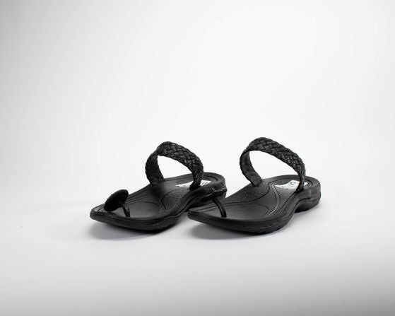 women braided leather sandal with toa button . top angle view