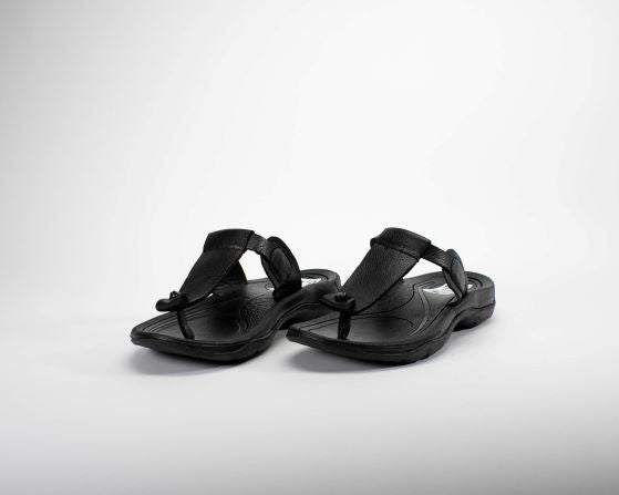 T-strap black leather sandals for women. Top angle view