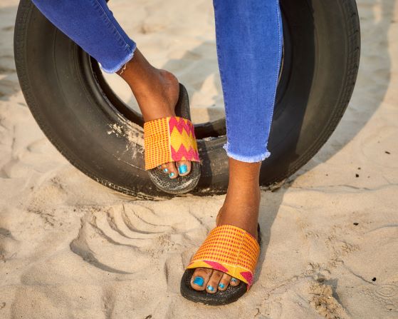 Woman life style image on a beach with pink slid . Upper view