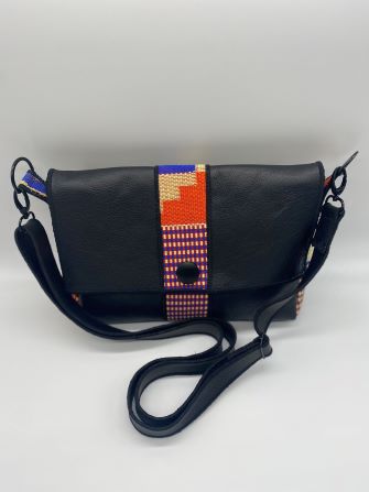 orange kente woven and black leather comb bag top view