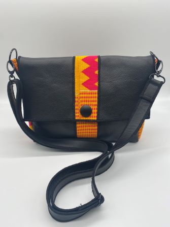 pink kente woven and black leather comb bag top view