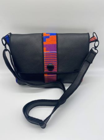 purple kente woven and black leather comb bag top view