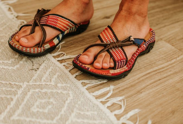 Men orange kente woven sandal with leather. Side view.