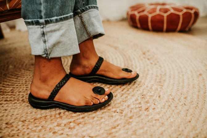 women braided leather sandal with toa button . top view