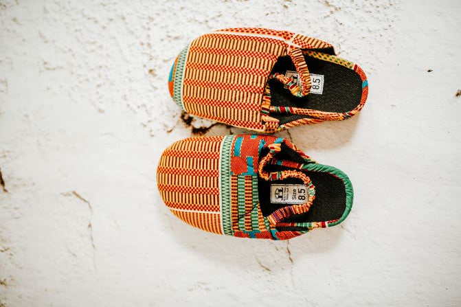 women yellow and green kente print mule, top view.