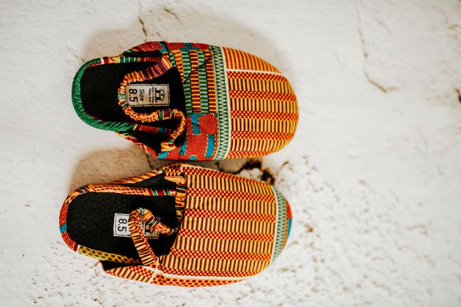 women yellow green kente print mule side and top view.